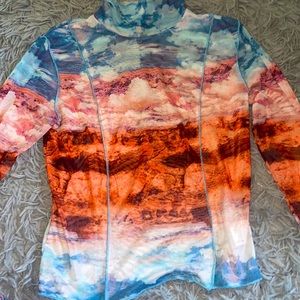 Turtle neck see through mesh top. Beautiful blue orange and pink designs.